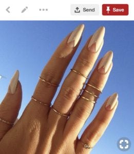 Pinterest image of white almond shaped nails with negative space triangles
