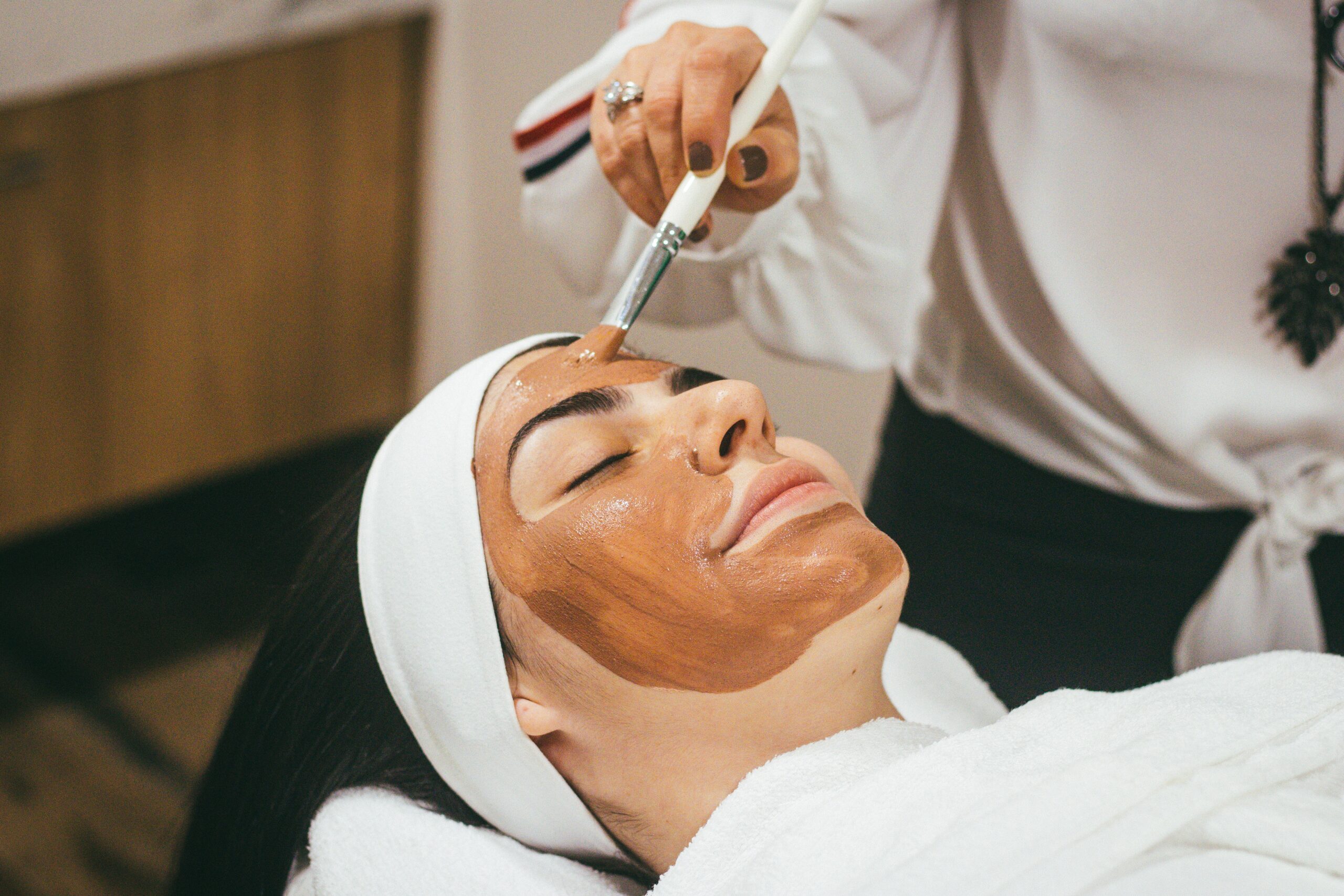 woman receiving facial treatments at a spa